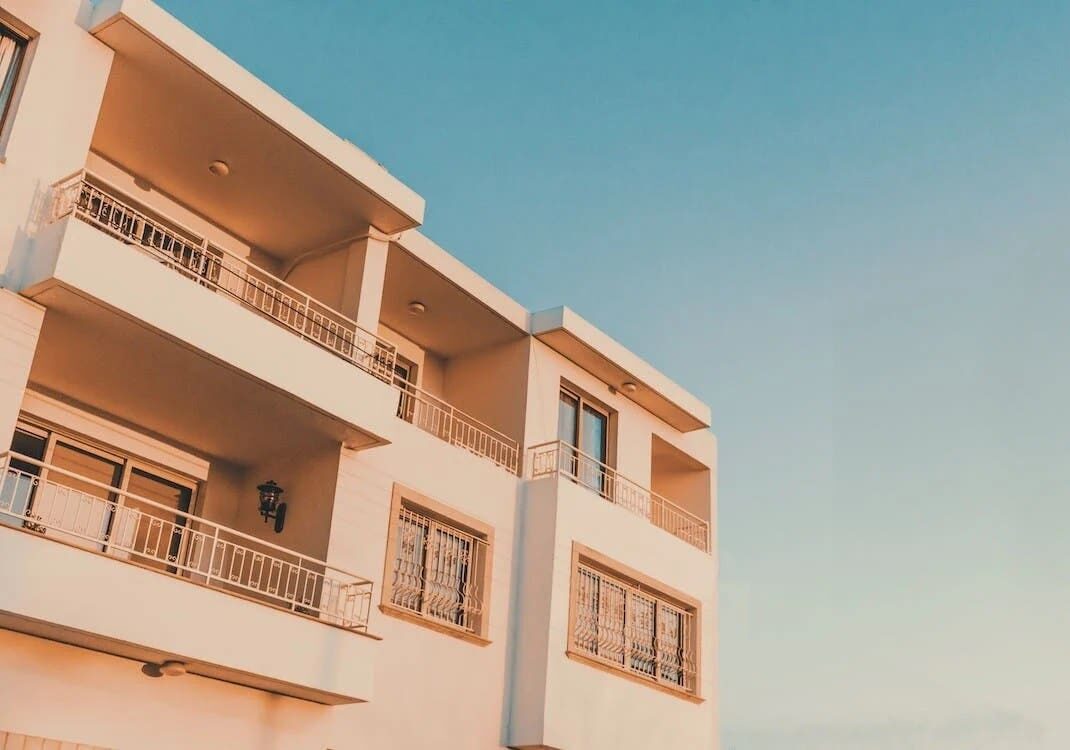 A block of apartments with the blue sky in the background. 