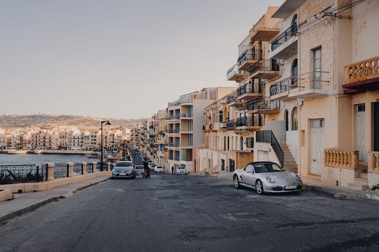 Property in Malta with cars parked outside. 