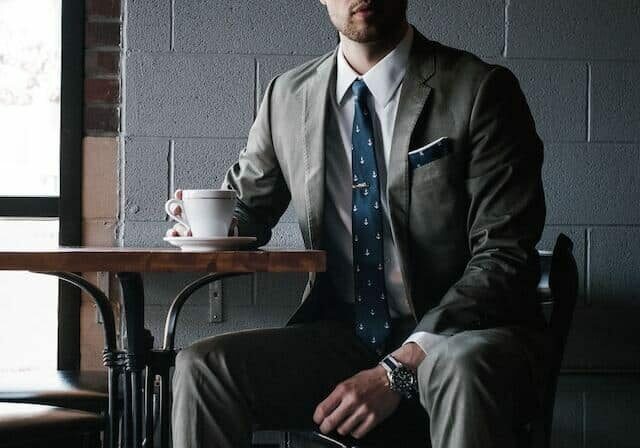 golden visa portugal lawyer sitting at a cafe table having a coffee