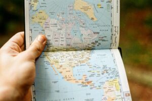 Hand holding open a physical map book - what is a second residence?