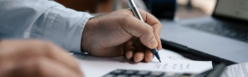 person calculating the cost of the Latvia Golden Visa 