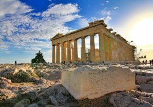 Ancient ruins in Greece with sun shining in the background - top European countries to live in for expats