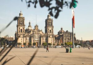 Metropolitan Cathedral at Zocalo main square and Mexican flag in foreground - where to retire abroad if you're a US citizen