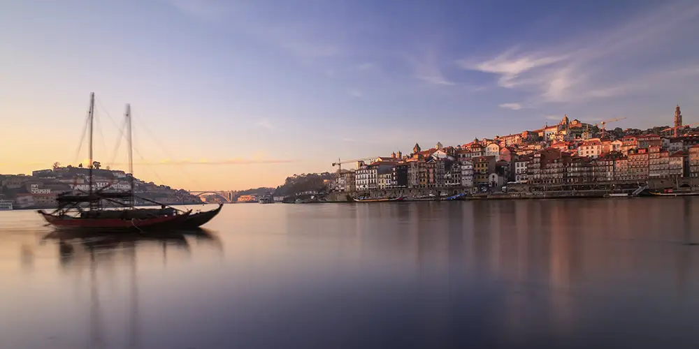 view of the douro river with a rebelo boat and porto's downtown