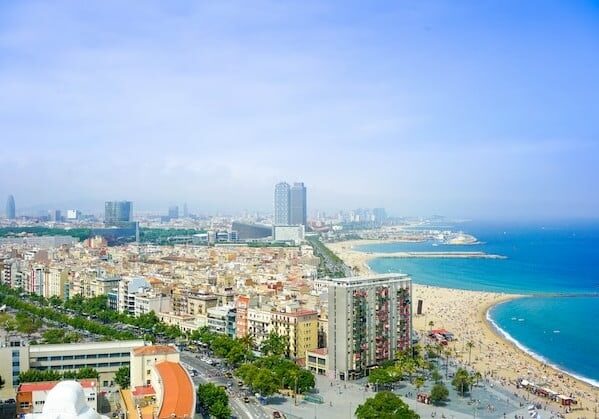 An aerial view of Barcelona with the ocean in the background. 