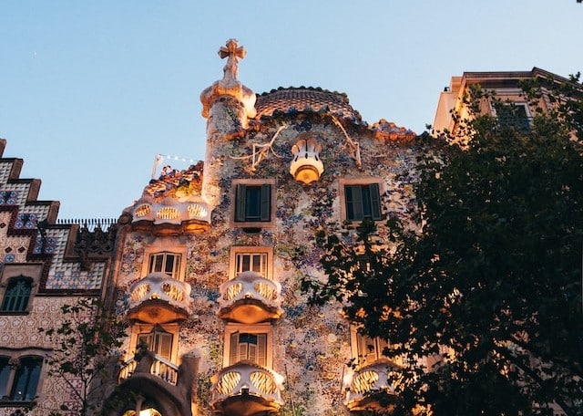 Ornamental buildings lit up at dusk in Barcelona, Spain - European country for Americans to retire in