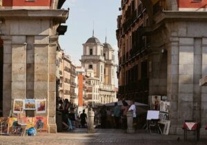 Plaza in Madrid, Spain with sellers displaying art - Spain golden visa 
