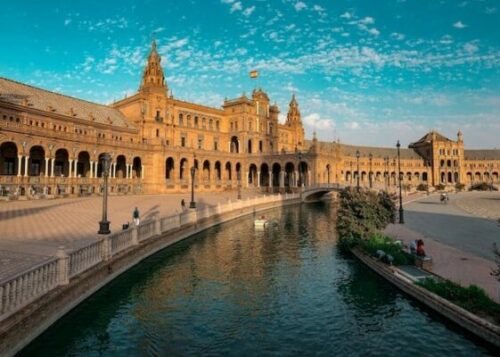 A monument building in Sevilla Spain with a stream of water in the front.  