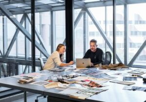 Two people sitting at an office desk discussing ways to to avoid Turkey citizenship by investment delays