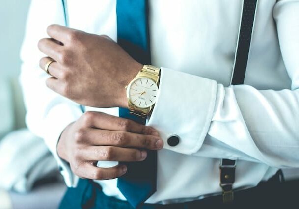 a professional man putting on cufflinks