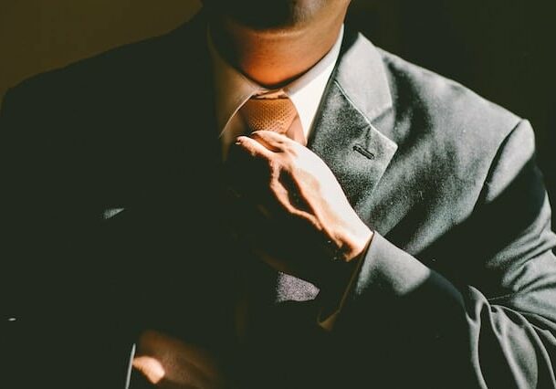 a professional man fixing his tie