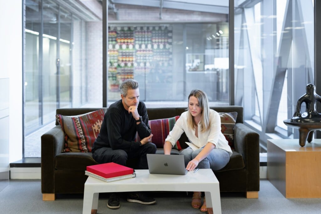 Two people looking at a laptop