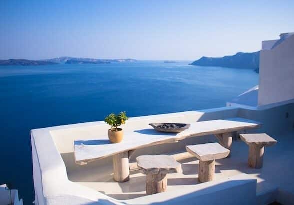 Concrete table on a Greek house's balcony overlooking the ocean - Greece golden passport