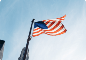 American flag waving against a blue sky background - Countries With No Extradition Treaty With the US