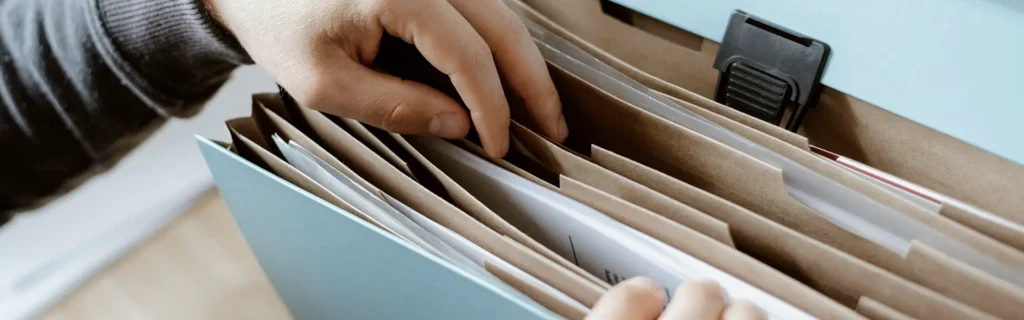 Hands sifting through documents for Serbia Residence Permit for Russians  
