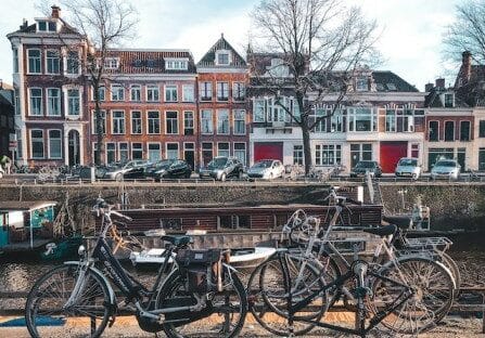 Classic colorful Dutch buildings and bicycles lining a canal in Netherlands - one of the best countries for expats to live in