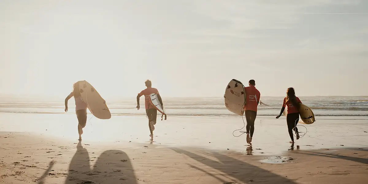 surfers in a beach in peniche