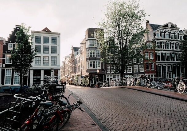 Bridge with bicycles crossing over to quaint Dutch houses alongside a river in Netherlands - Top 10 crypto-friendly country in Europe
