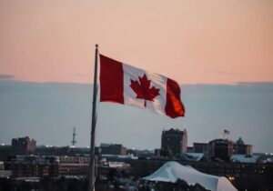 Canada flag over a city in the afternoon
