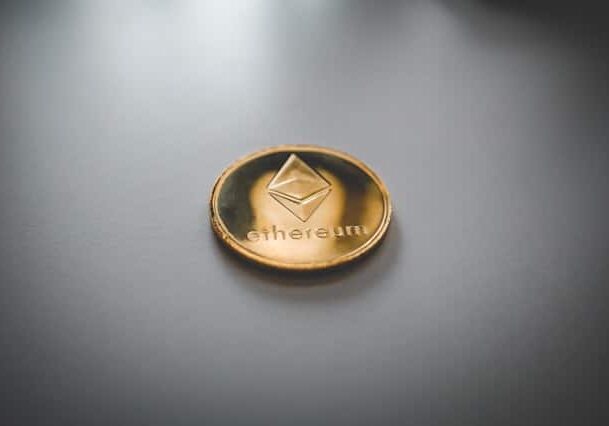 A single Ethereum coin on top of dark gray shiny surface - Cryptocurrency ranked