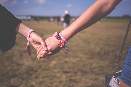 Two women holding hands 