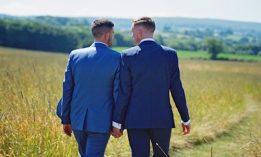 Two men holding hands 