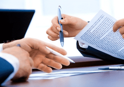 People signing documents 