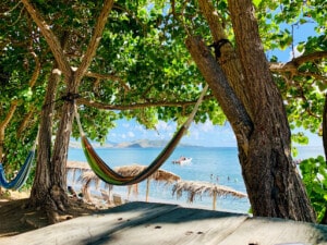 Hammock hanging in between trees on a beach in St Kitts and Nevis - moving out of the USA and top destinations