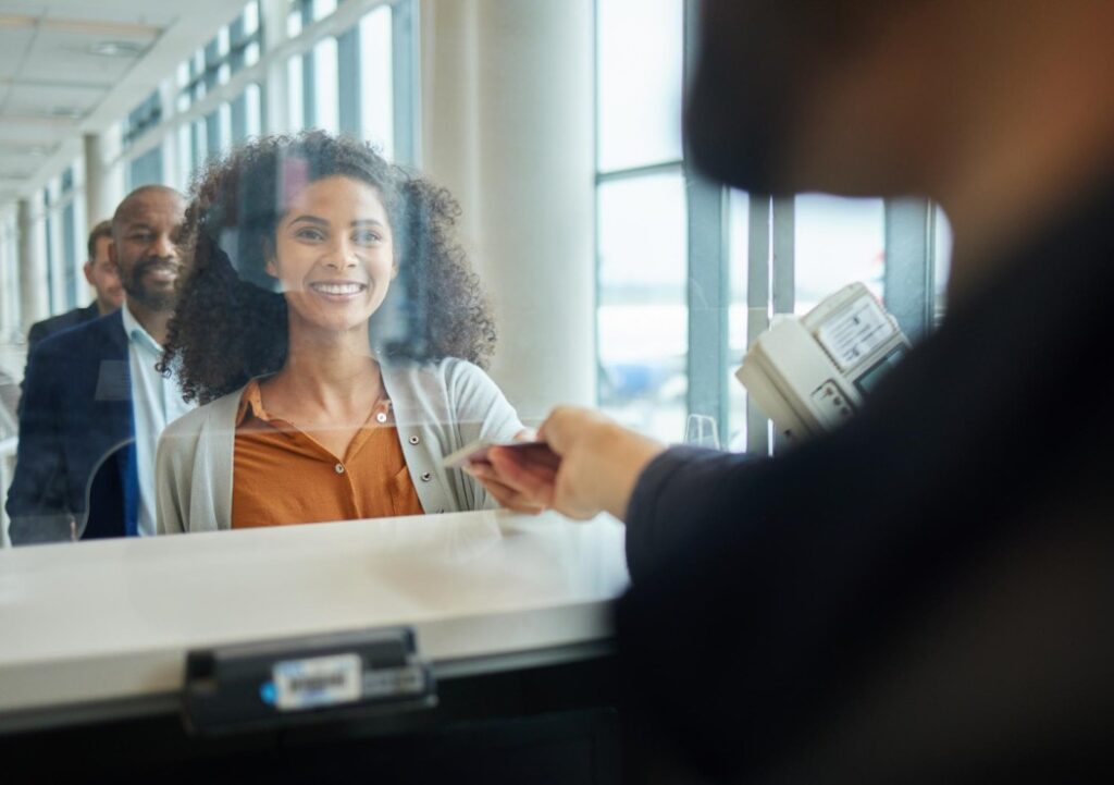 dark haired woman standing in front of a st kitts and nevis bank branch assistant opening account