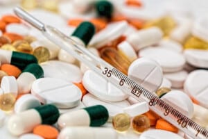 Close-up of colorful medication and a thermometer