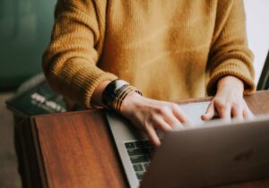 Person sitting behind a laptop