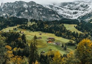 View of the Swiss countryside with snowy mountains in the background - least corrupt countries