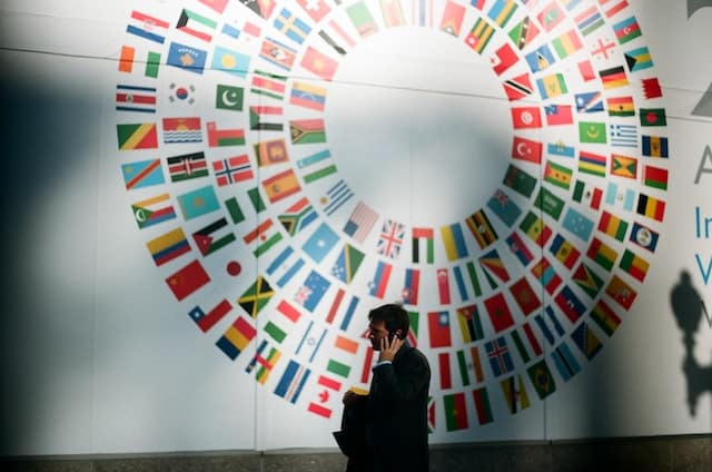 Mural with a circle showing all of the countries' flags - Residency by investment vs citizenship by investment comparison
