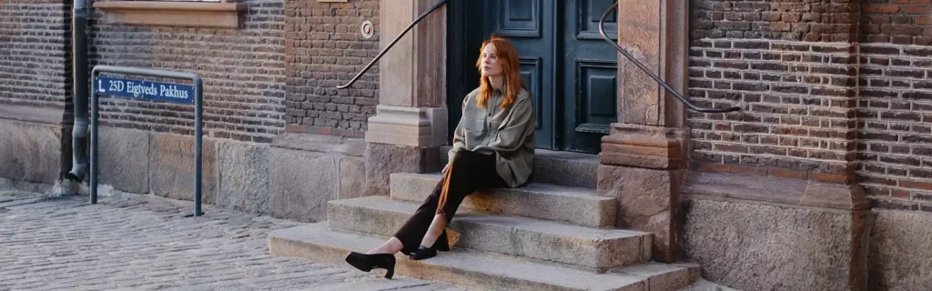 woman sit in Copenhagen, Denmark, as one of the safest countries for women.
