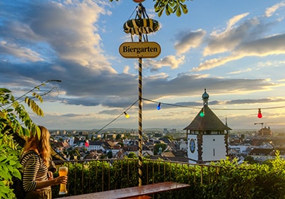 Woman drinking a beer in a biergarten in Germany - country in Europe that's woman-friendly