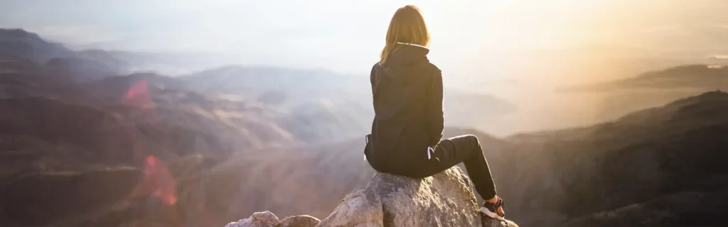 woman sit with landscape in one of the safest countries