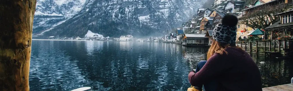 Woman sit next to an austrian village