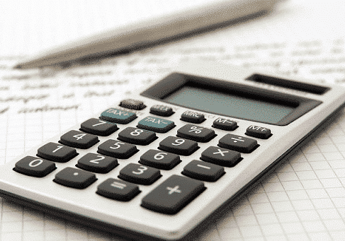 calculator on a notebook with a pen