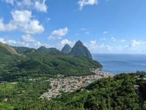 aerial view of soufrière, st lucia, and piton mountain range in the distance