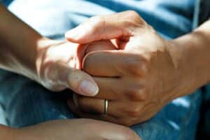 close up of two hands holding each other