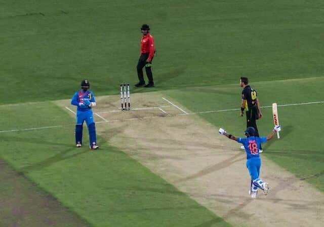 view of cricket players and umpire at a match in Daren Sammy National Cricket Stadium in st lucia