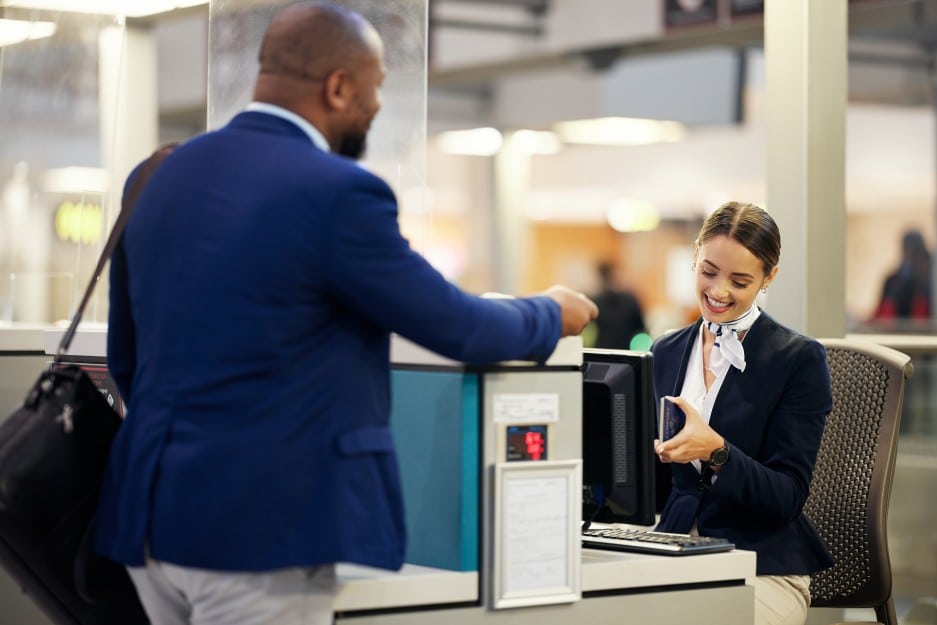 grenada passport holder checking in at airport desk with urgent passport