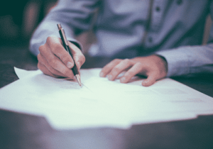 A person signing documents 