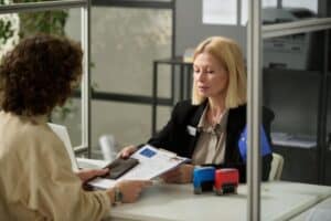 a women at a counter apply for antigua and barbuda tourist visa with a female immigration officer