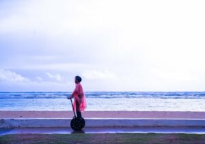 a person riding a segway on a beach