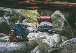 two backpacks and hiking booths on rocks in Signal Hill antigua