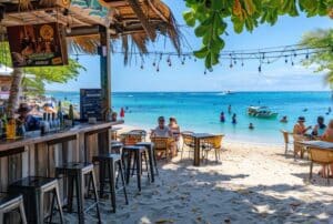 view of the ocean and people swimming from a beach bar in antigua