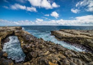 waves crashing on rocks in antigua barbuda devils bridge