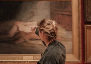 a woman looking at a painting in Museum of Antigua & Barbuda