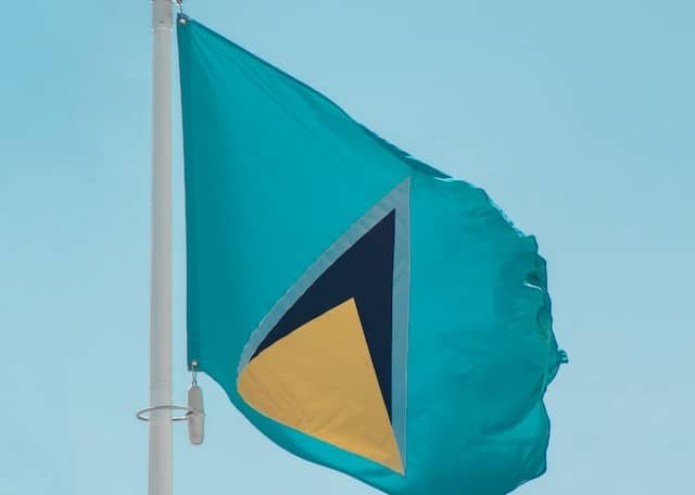 St Lucia flag waving against a blue sky - CBI in Caribbean